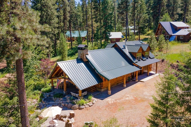 bird's eye view with a wooded view