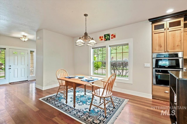 12970 N 9th Ave, Boise, ID 83714 - dining room featuring baseboards, a chandelier, and dark wood finished floors