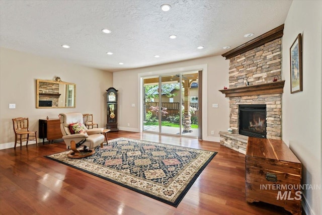 12970 N 9th Ave, Boise, ID 83714 - living area featuring a textured ceiling, wood finished floors, recessed lighting, a fireplace, and baseboards