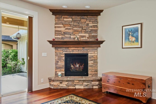 12970 N 9th Ave, Boise, ID 83714 - detailed view of wood finished floors, a stone fireplace, and baseboards