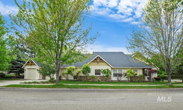12970 N 9th Ave, Boise, ID 83714 - view of front of house with driveway, stone siding, and board and batten siding