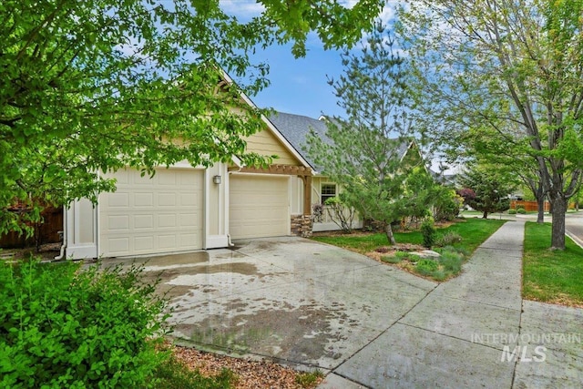 12970 N 9th Ave, Boise, ID 83714 - view of front of house featuring driveway, stone siding, and an attached garage