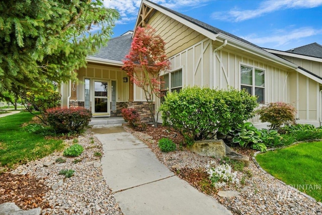 12970 N 9th Ave, Boise, ID 83714 - view of front of home with board and batten siding, covered porch, and a shingled roof
