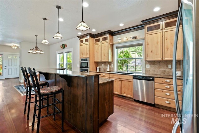12970 N 9th Ave, Boise, ID 83714 - kitchen featuring appliances with stainless steel finishes, a sink, light brown cabinets, decorative backsplash, and recessed lighting