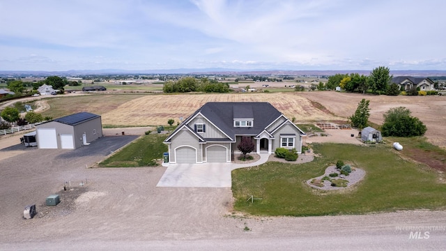 view of front facade with driveway, a front lawn, central AC, and a rural view