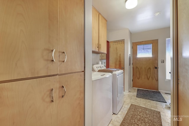 washroom featuring cabinets and washer and dryer