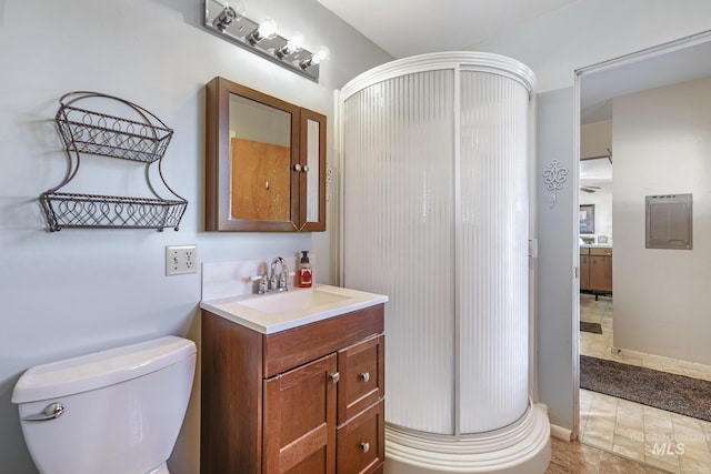 bathroom with a shower with door, vanity, and toilet