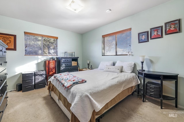 carpeted bedroom featuring multiple windows