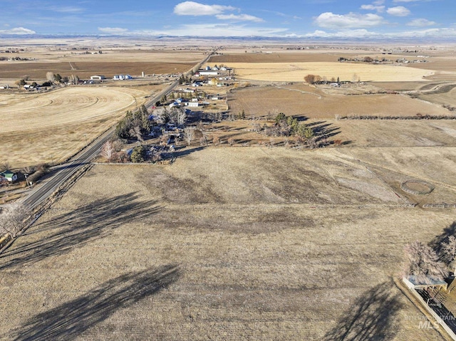 birds eye view of property with a rural view