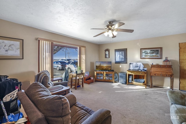 living room with ceiling fan, carpet, and a textured ceiling