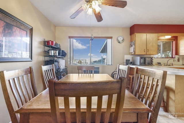 dining area with sink and ceiling fan