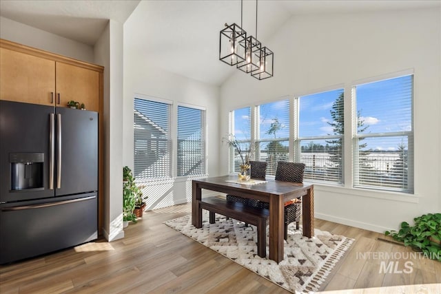 8237 W Corinthia St, Eagle, ID 83616 - dining room featuring high vaulted ceiling, a chandelier, and light wood finished floors