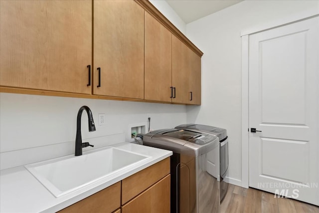 8237 W Corinthia St, Eagle, ID 83616 - laundry area featuring cabinet space, washing machine and dryer, and light wood-type flooring