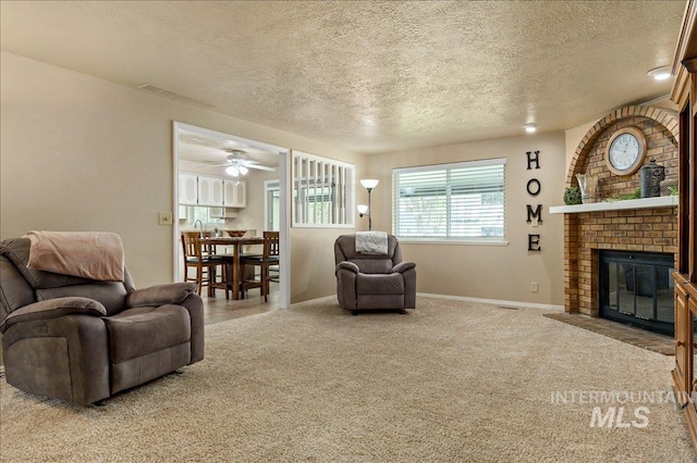 living room featuring a brick fireplace, carpet flooring, visible vents, and baseboards