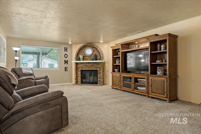 living room featuring a brick fireplace, carpet, visible vents, and a textured ceiling