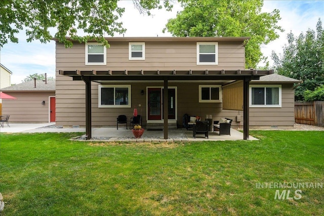 rear view of property with crawl space, a patio area, fence, and a yard