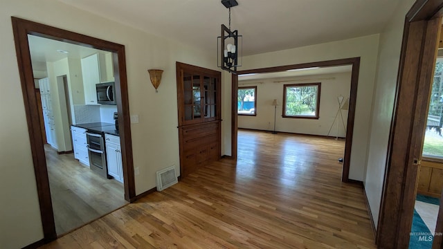 815 E 6th, Moscow, ID 83843 - hall with light wood-type flooring and baseboards