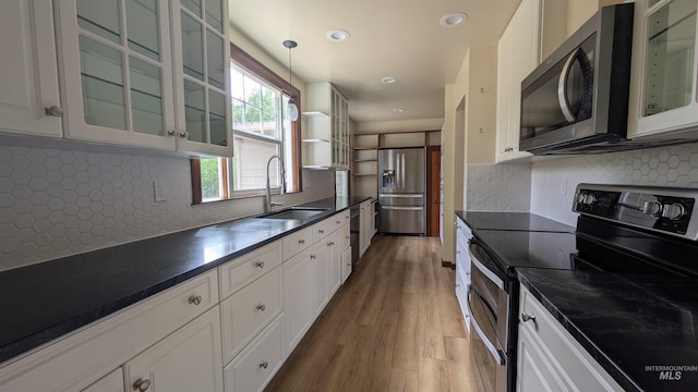 815 E 6th, Moscow, ID 83843 - kitchen featuring stainless steel appliances, wood finished floors, dark countertops, white cabinetry, and recessed lighting