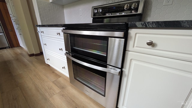 815 E 6th, Moscow, ID 83843 - kitchen with double oven range, light wood-style floors, dark countertops, and backsplash