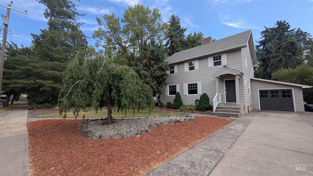 815 E 6th, Moscow, ID 83843 - colonial inspired home featuring driveway, a garage, and a chimney