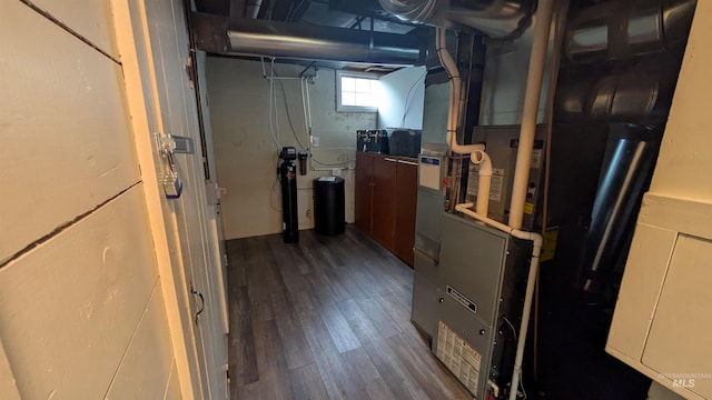 815 E 6th, Moscow, ID 83843 - below grade area featuring dark wood finished floors, heating unit, and a water softener