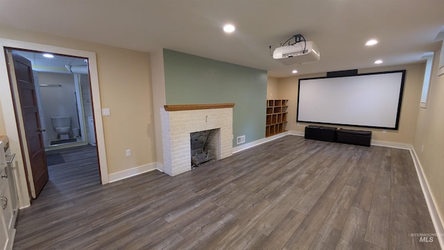 815 E 6th, Moscow, ID 83843 - cinema room with dark wood-style flooring, recessed lighting, and a brick fireplace