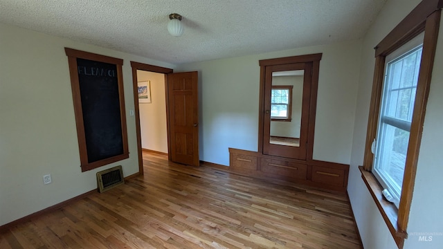 815 E 6th, Moscow, ID 83843 - spare room with light wood-style flooring and a textured ceiling
