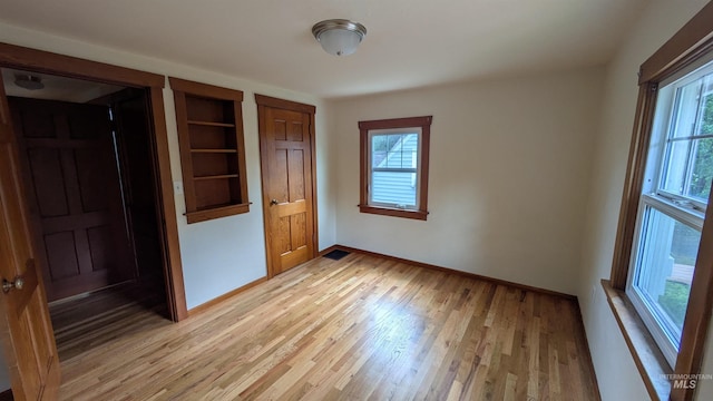 815 E 6th, Moscow, ID 83843 - spare room featuring light wood finished floors and built in shelves
