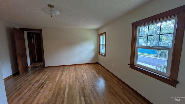 815 E 6th, Moscow, ID 83843 - unfurnished room featuring a textured ceiling and light wood-style floors