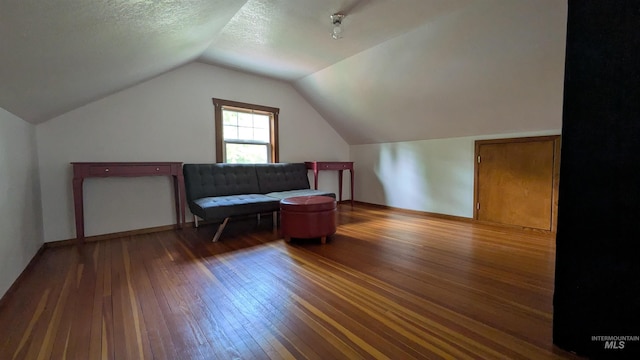 815 E 6th, Moscow, ID 83843 - additional living space with hardwood / wood-style flooring, vaulted ceiling, and a textured ceiling
