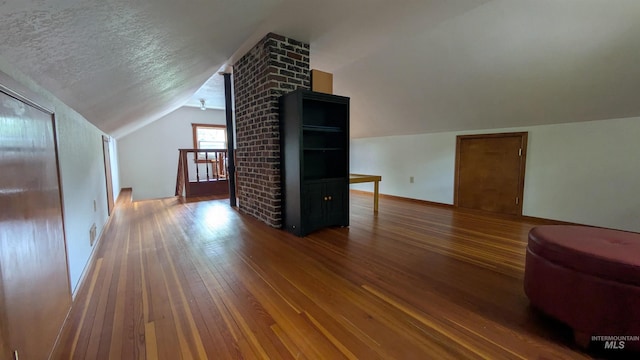 815 E 6th, Moscow, ID 83843 - bonus room with vaulted ceiling, wood-type flooring, and a textured ceiling