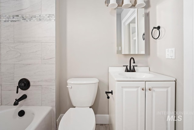 full bathroom with toilet, vanity, and tiled shower / bath combo