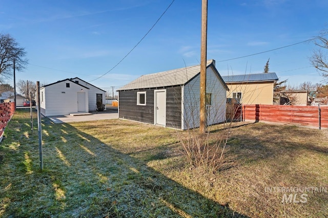 exterior space featuring an outdoor structure and a lawn