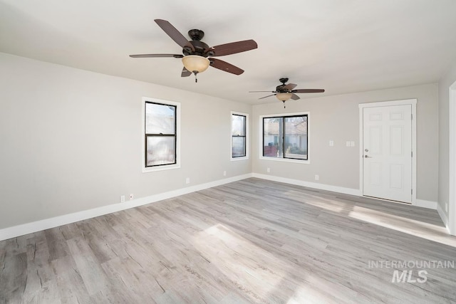 empty room with light wood-type flooring and ceiling fan