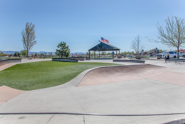 surrounding community featuring a gazebo, a lawn, and a mountain view