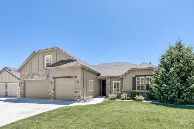 13569 Paoletti St, Caldwell, ID 83607 - view of front of home featuring an attached garage, driveway, board and batten siding, a front yard, and a shingled roof