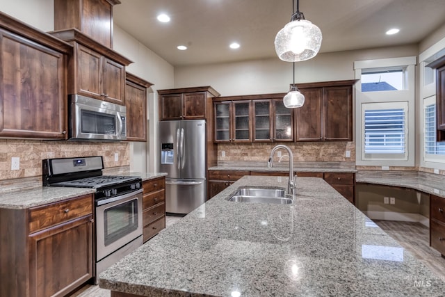 13569 Paoletti St, Caldwell, ID 83607 - kitchen with stainless steel appliances, light stone countertops, hanging light fixtures, tasteful backsplash, and recessed lighting