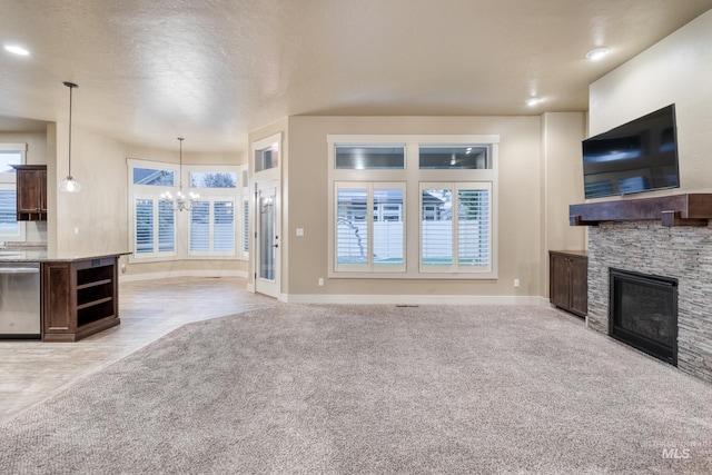13569 Paoletti St, Caldwell, ID 83607 - unfurnished living room featuring a chandelier, a fireplace, light colored carpet, a textured ceiling, and recessed lighting