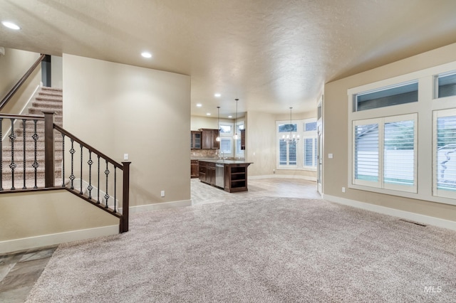 13569 Paoletti St, Caldwell, ID 83607 - unfurnished living room with recessed lighting, light colored carpet, and stairway