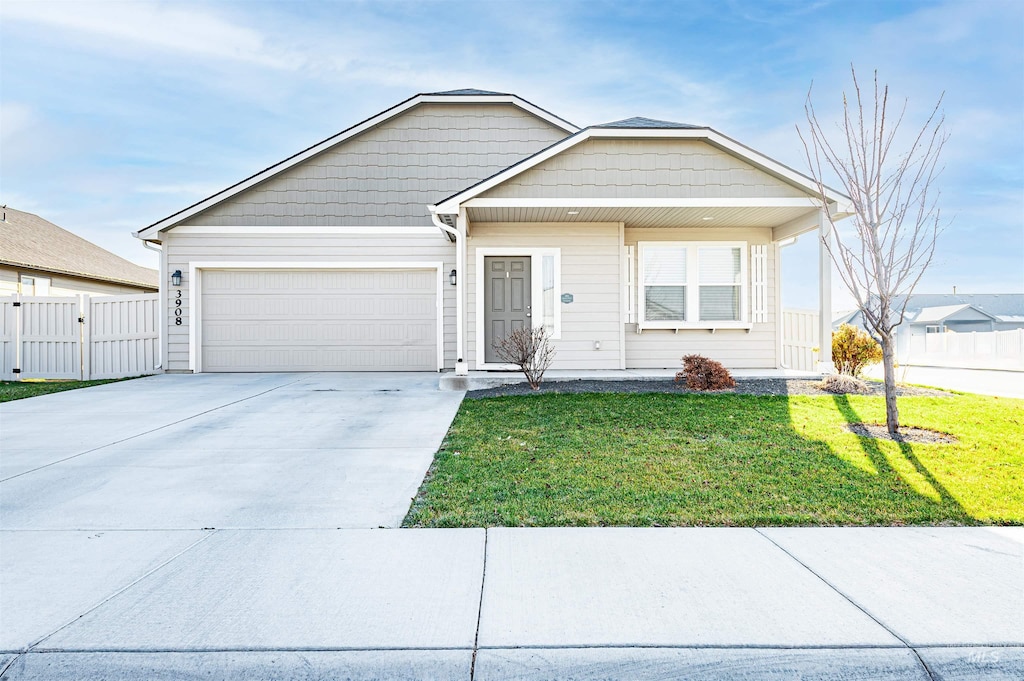 view of front of property with a front yard and a garage