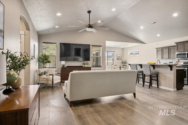 1046 N Warm River Ave, Kuna, ID 83634 - living area with light wood-type flooring, recessed lighting, a textured ceiling, a ceiling fan, and lofted ceiling