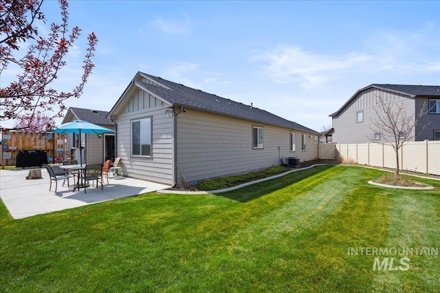 1046 N Warm River Ave, Kuna, ID 83634 - back of house featuring a patio area, a fenced backyard, central AC, and a lawn