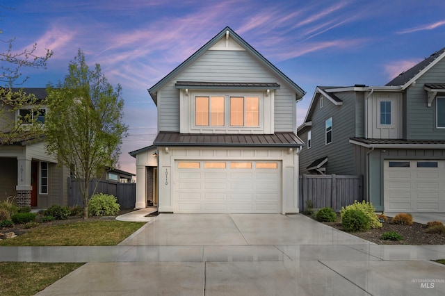 10110 Irongate Dr, Nampa, ID 83687 - traditional-style house featuring an attached garage, driveway, fence, and a standing seam roof