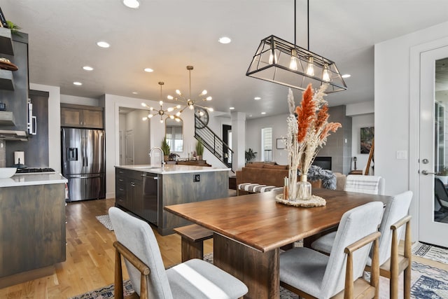 10110 Irongate Dr, Nampa, ID 83687 - dining area with light wood finished floors, recessed lighting, and a notable chandelier
