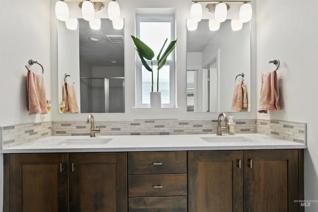 10110 Irongate Dr, Nampa, ID 83687 - bathroom with a shower stall, tasteful backsplash, a sink, and double vanity