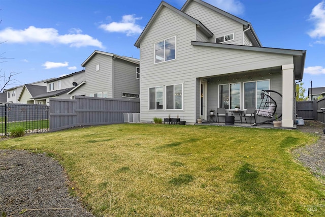 10110 Irongate Dr, Nampa, ID 83687 - back of house featuring an outdoor living space, a patio area, central air condition unit, a fenced backyard, and a yard