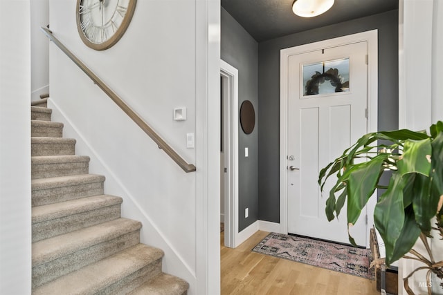 10110 Irongate Dr, Nampa, ID 83687 - entryway featuring baseboards, wood finished floors, and stairs