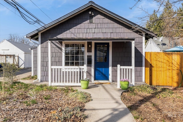 view of front of house with covered porch and fence