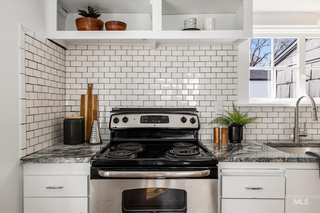 kitchen with a sink, backsplash, white cabinets, and stainless steel range with electric cooktop