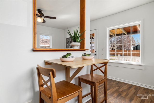 dining area with dark wood-style floors, baseboards, and ceiling fan